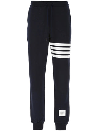 Classic sweatpants by Thom Browne. Tailored in 100% cotton with the iconic 4-Bar motif, a comfortable drawstring waist, and signature grosgrain loop tab.