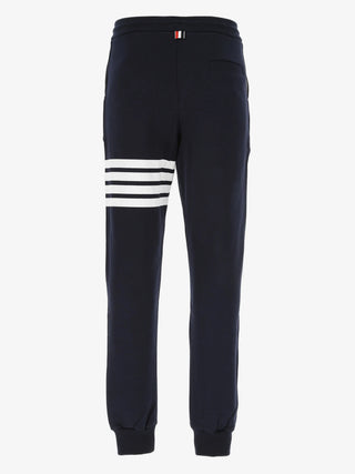 Classic sweatpants by Thom Browne. Tailored in 100% cotton with the iconic 4-Bar motif, a comfortable drawstring waist, and signature grosgrain loop tab.