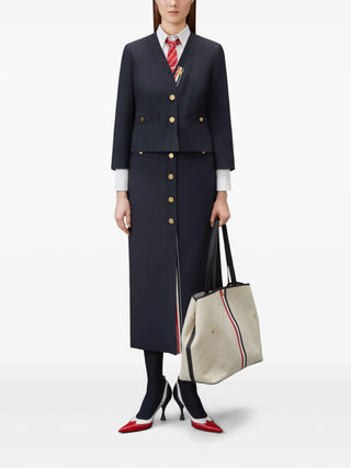 Thom Browne high-waisted midi skirt. Crafted in 100% wool with silk lining, RWB-stripe grosgrain tab and drop-in pockets. Available at our Lisbon store. 