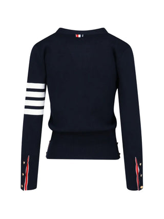 A refined V-neck cardigan from Thom Browne's Milano line. Features buttoned side vents, signature 4-Bar detailing, and a grosgrain loop tab at the back. 