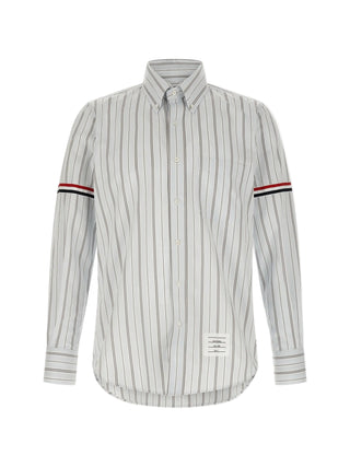 Poplin armband shirt by THOM BROWNE. Stripe poplin, button-down collar, patch pocket, and signature loop tab. Available at our Lisbon store. 