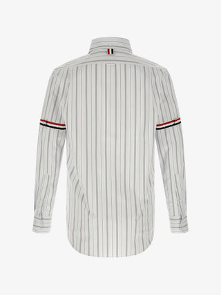 Poplin armband shirt by THOM BROWNE. Stripe poplin, button-down collar, patch pocket, and signature loop tab. Available at our Lisbon store. 