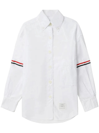 Supersized point collar shirt by Thom Browne. Crisp cotton Oxford or linen with signature 4-Bar stripe and button-down collar. Available at our Lisbon store. 