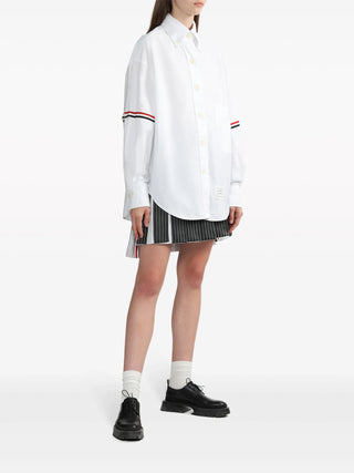 Supersized point collar shirt by Thom Browne. Crisp cotton Oxford or linen with signature 4-Bar stripe and button-down collar. Available at our Lisbon store. 