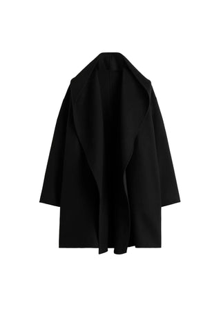 TOTEME hooded coat. Warm wool-blend felt, loose silhouette, generous hood, and patch pockets. Classic outerwear, available at our Lisbon store. 