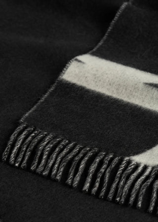 Scarf crafted in Italy from brushed wool, finished with a monogram and contrasting fringe. A classic piece that layers easily over winter outerwear.