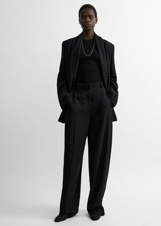 High-waist trousers crafted from softly structured flannel with straight, wide legs and pressed front creases. Available at our Lisbon store. 