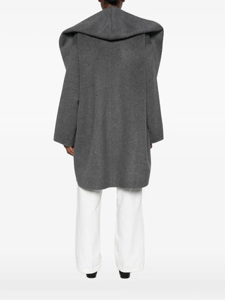 TOTEME grey wool hooded coat. A relaxed, oversized silhouette in 100% wool with an open front. Available at our Lisbon store. 