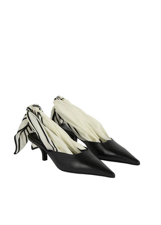 Sharp-toed mules that reimagine the signature TOTEME silk scarf as a slingback tie. Crafted in Italy from soft nappa leather and set on a sculptural 55mm heel.