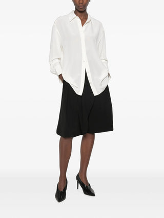 TOTEME's silk crepe shirt. Luxuriously fluid, with a relaxed fit and subtle sheen. Effortless elegance for any wardrobe. Available at our Lisbon store. 