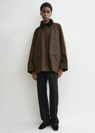 TOTEME Zipped Country Jacket. Relaxed, oversized fit in organic waxed cotton. Features a corduroy collar, zip fastening, and patch pockets. 