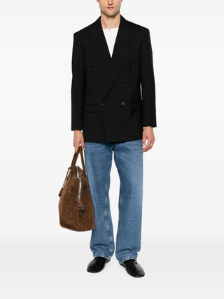 The Row black Mazzy double-breasted blazer with peak lapels and tailored fit. Clean and refined, available at our Lisbon store.