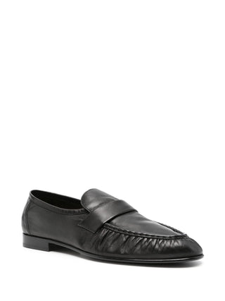 Almond-toe loafer by The Row. Soft nappa leather apron front with a block heel. Refined minimalism with a debossed branded insole. Available at our Lisbon store