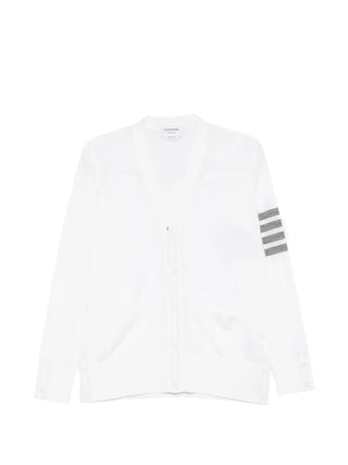 Thom Browne white Classic V-neck cardigan with grey stripes, button fastening and front pockets. Refined everyday layer. Available at our Lisbon store.