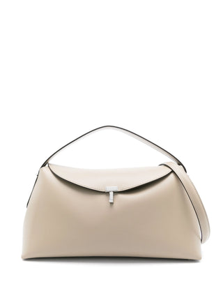 Sculptural leather clutch with a signature T-lock closure. A minimalist statement piece for day or night, crafted from premium leather.