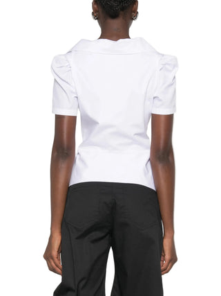 Vivienne Westwood Monday shirt. Origami-like neckline folds, puffed shoulders, and a signature multi-coloured Orb at the hip. Available at our Lisbon store.