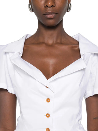 Vivienne Westwood Monday shirt. Origami-like neckline folds, puffed shoulders, and a signature multi-coloured Orb at the hip. Available at our Lisbon store.