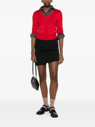 Vivienne Westwood black Mini Infinity high-waisted skirt with asymmetric hem and dart detailing, ideal from day to evening. Available at our Lisbon store.