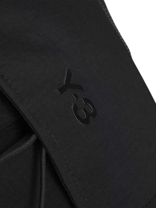 Close-up of a black textured surface with a Y-3 logo embossed on it.