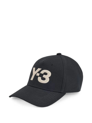 Y-3 logo-patch baseball cap in black. Embroidered front logo, curved peak, six-panel construction, and adjustable strap. Available at our Lisbon store.