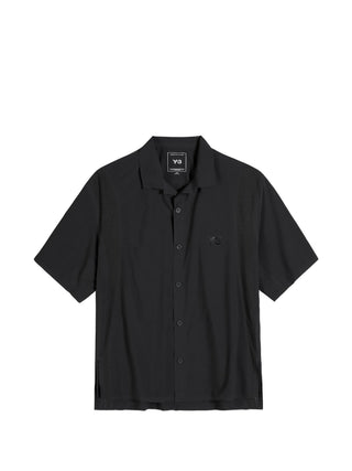 Y-3 black short-sleeve shirt with perforated detailing, side slits and button fastening. Lightweight and modern, available at our Lisbon store.
