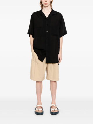 Yohji Yamamoto black Cuban-collar short-sleeve shirt with chest pocket and relaxed fit. Refined and easy, available at our Lisbon store.
