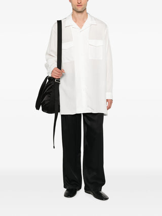 Yohji Yamamoto white flap-pocket shirt with open collar and relaxed fit. Lightweight and versatile, available at our Lisbon store.