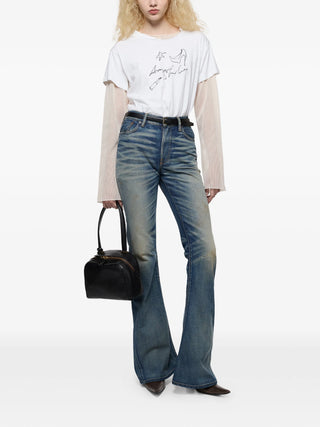 Person wearing a white t-shirt, beige cardigan, blue jeans, and holding a black handbag by Acne Studios