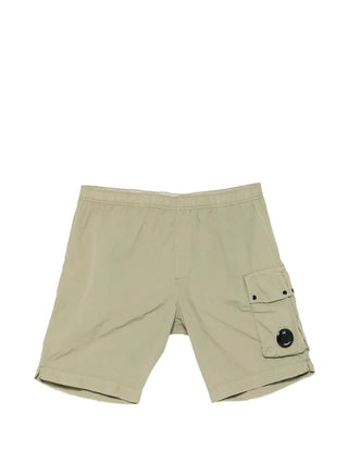 C.P. Company's Flatt Nylon cargo swim shorts. Mixed lens detailing meets hybrid functionality. Available at our Lisbon store.