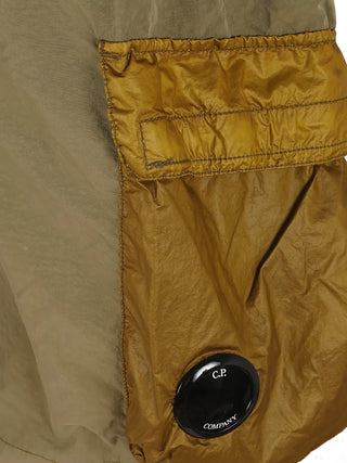 Engineered in mixed nylon with a signature lens pocket, these C.P. Company cargo swim shorts offer style, function, and quick-dry performance.