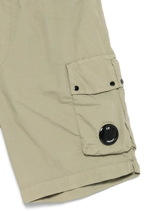C.P. Company's Flatt Nylon cargo swim shorts. Mixed lens detailing meets hybrid functionality. Available at our Lisbon store.