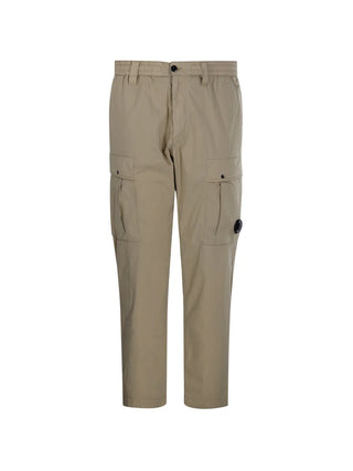C.P. Company cargo trousers. Iconic utility wear with signature lens detailing. Durable fabric and functional pockets for everyday style. 