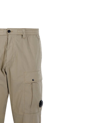 C.P. Company cargo trousers. Iconic utility wear with signature lens detailing. Durable fabric and functional pockets for everyday style. 