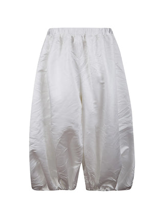 White pants with elasticated waist and tappered at the knee by Comme Des Garcons