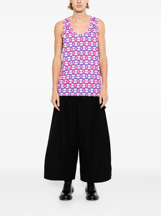 Fusia pink tank top worn with Black trousers and black boots.