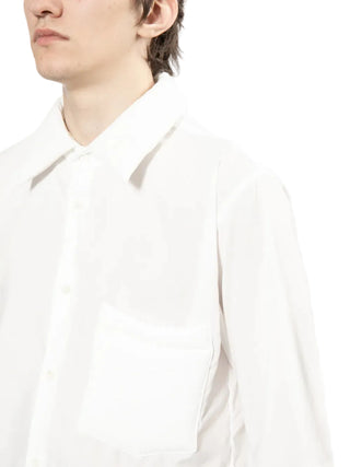 Close-up of a person wearing a white shirt on a white background