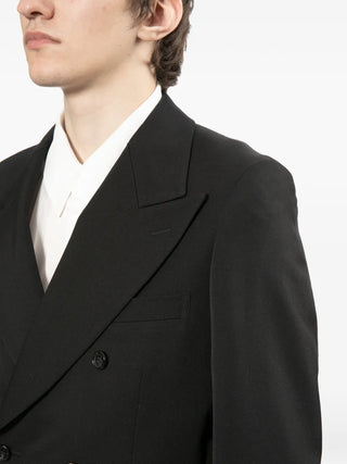 Black suit jacket worn by a person on a white background