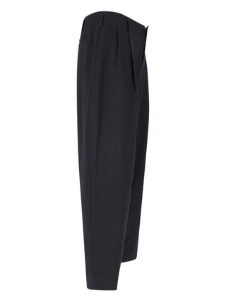 Black woolen long trousers by Comme des Garcons Homme Plus