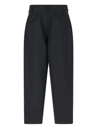 Black woolen long trousers with back poket and belt loops by Comme des Garcons Homme Plus. 