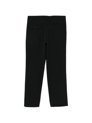 Black trousers with single pocket at the back and zip detail on the front by comme des Garcons. 