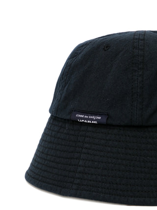 Black bucket hat with a brand label on a white background