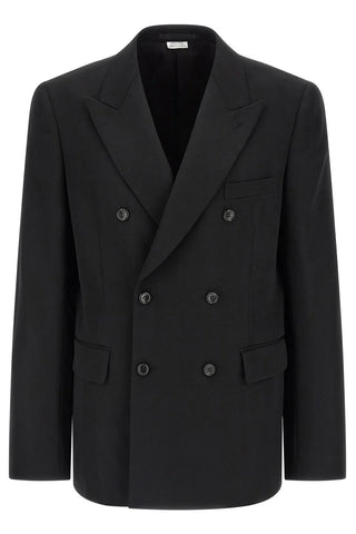 Black long sleeved double breasted blazer with pockets by Comme des Garcons. 