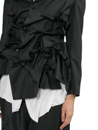 Black jacket layered over a white shirt with black pants