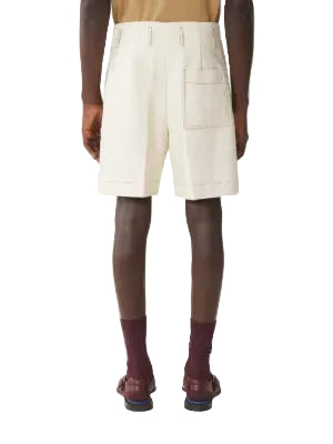Person wearing beige shorts by Lanvin