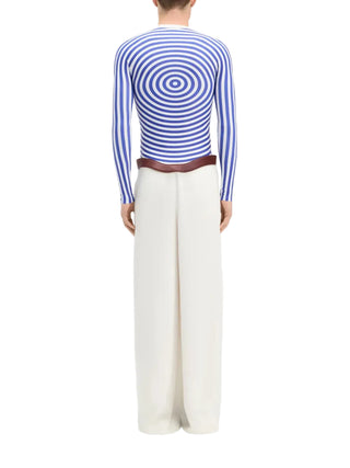 Person wearing a blue and white striped long-sleeve top with wide-leg pants 