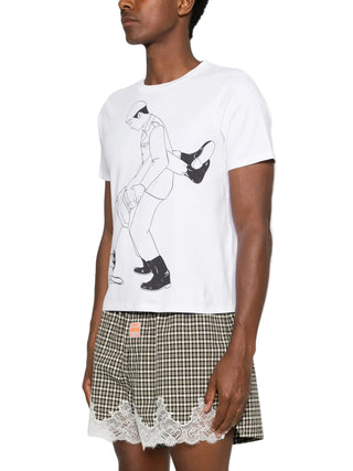 Person wearing a white t-shirt with a graphic design and a checkered shorts with lace trim.