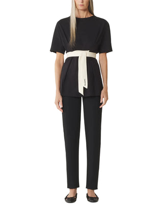 Woman wearing a black outfit with a white belt by Lanvin