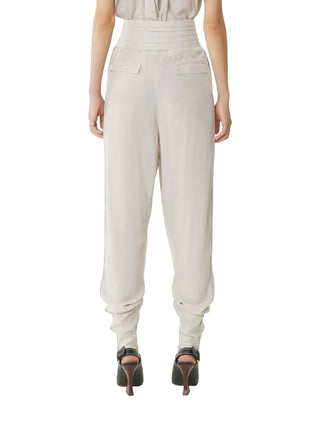 Person wearing beige high-waisted pants by Lanvin