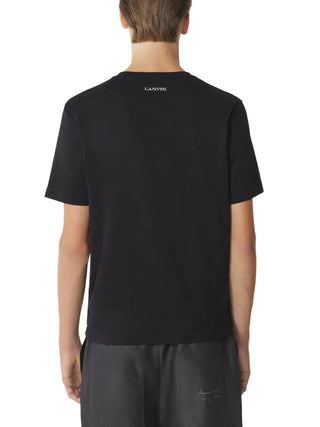 Person wearing a black t-shirt with 'LANVIN' branding on the back
