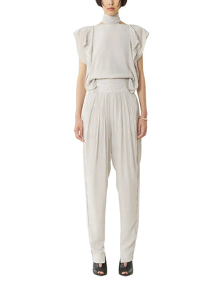 Woman wearing an off white outfit with ruffled sleeves by Lanvin